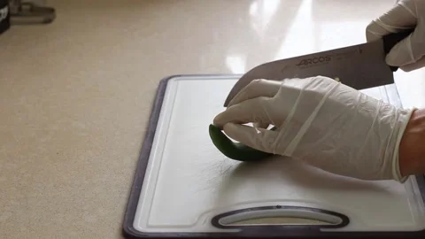 A man cuts hot pepper on a plastic cutting board Stock Footage 167271410