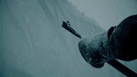 A man cuts ice with a tool, winter city scenery Video stock 121798159