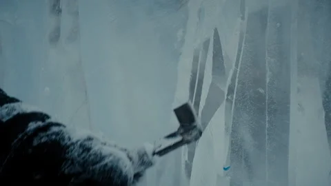 A man cuts ice with a tool, winter city scenery Stock Footage 124632059