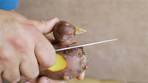 A man cuts with a knife the potato head duck. Kill the potato beast. Close-up, r Stock Footage 99743870