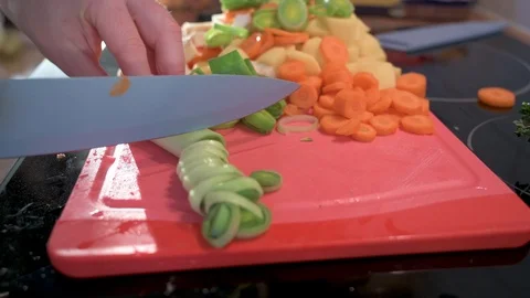 Man cuts leeks into small pieces with a knife 2 Stock Footage 124679033