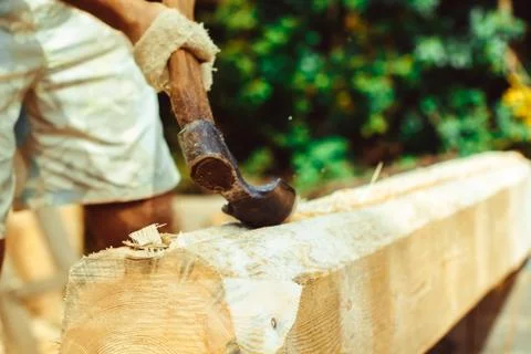A man cuts a log Stock Photos