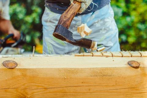 A man cuts a log Stock Photos
