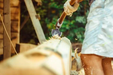 A man cuts a log Photos