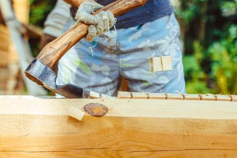 A man cuts a log Stock Photos