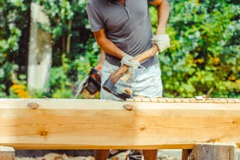 A man cuts a log Stock Photos