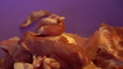 A man cuts meat and puts it in a basin Stock Footage 124047445