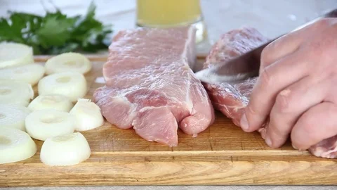 Man cuts meat Stock Footage 75467231