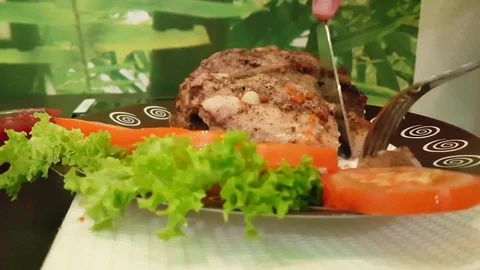 Man cuts meat on a plate Stock Footage 82950082