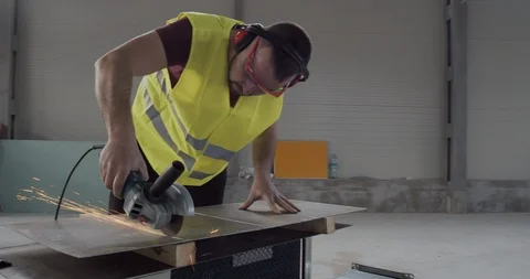 A man cuts a metal with an angular grinder. Stock Footage 126999318