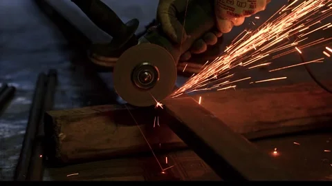 A man cuts metal using an angle grinder close-up. Many sparks Stock Footage 318463842