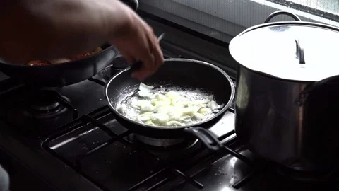 A man cuts the onion to make a fried. slow motion detail. About cooking, pasta Stock Footage 71305522