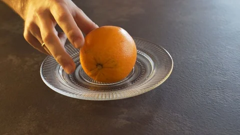 A man cuts an orange Stock Footage 124314323