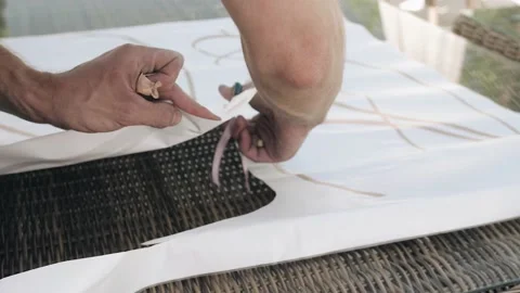 A man cuts paper with scissors. Shooting the decorator's hands in close-up Stock Footage 201969405