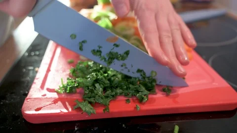Man cuts parsley into small pieces with a knife 2 Stock Footage 124679208