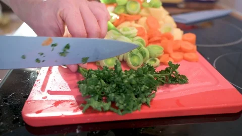 Man cuts parsley into small pieces with a knife Stock Footage 124679321