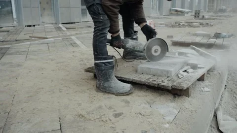 A man cuts paving slabs without protective equipment Stock Footage 302774666