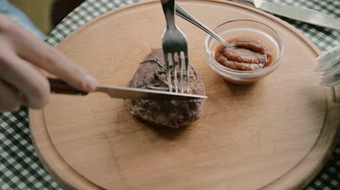 Man cuts off a piece of steak close-up Stock Footage 63230960