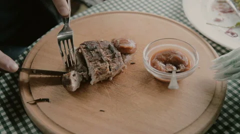 Man cuts off a piece of steak close-up Stock Footage 63232241