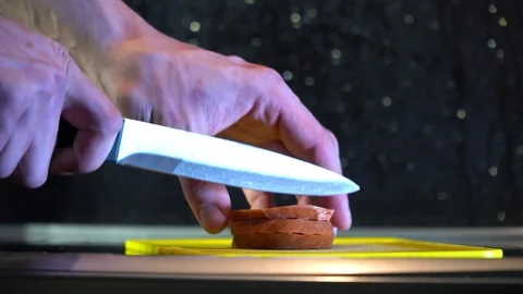 Man cuts pieces of meat on a cutting board in the kitchen Stock Footage 86156730