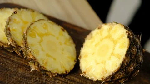 Man cuts pineapple into circles Stock Footage 127291089