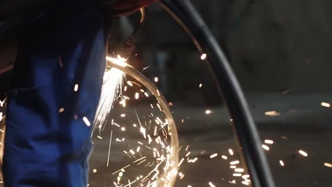 A man cuts a pipe with flame cutting torch to sparks in a workshop, slow motion 스톡 동영상 143665560