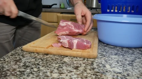 A man cuts the pork Stock Footage 101202197