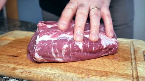 A man cuts the pork Stock Footage 101202655