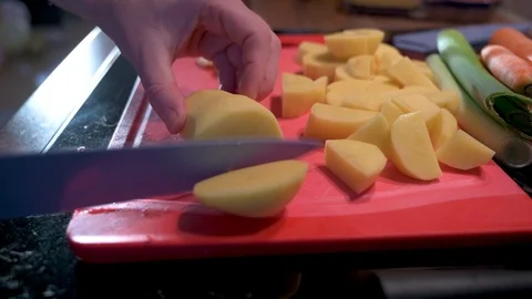 Man cuts potatoes into small pieces with a knife 2 Stock Footage 124679881