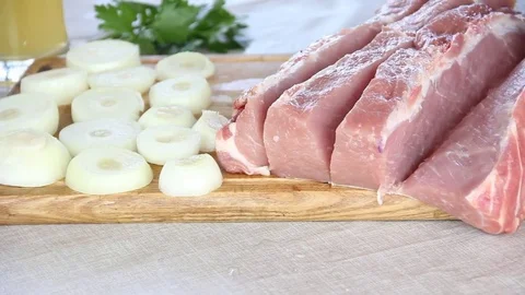 Man cuts raw meat Video stock 76579275