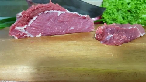 Man cuts raw meat in the kitchen food Video stock 83460054