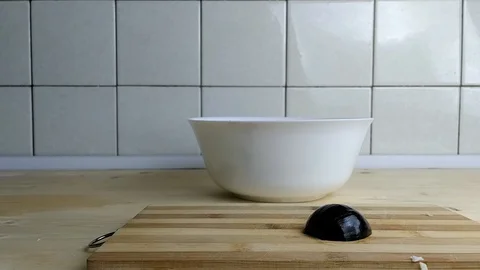 Man cuts red onion on a cutting board Video stock 129845301
