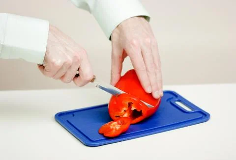 Man cuts the a red pepper. hands close-up Stock Photos