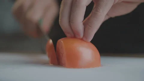 Man cuts red tomato with sharp knife. Slow Motion Video Stock Footage 103228744