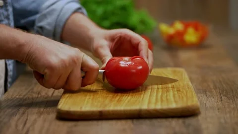 Man cuts red tomatoes. cooking process by the chef. salad ingredients. caring Stock Footage 201265664