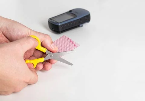 A man cuts off the required size of a protective film with scissors for gluing Stockfoto's