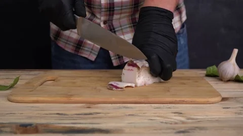 A man cuts salted lard with a sharp knife Stock Footage 146109671