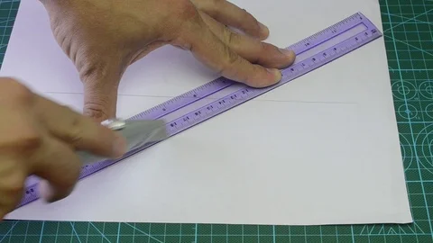 Man cuts a sheet of paper Stock Footage