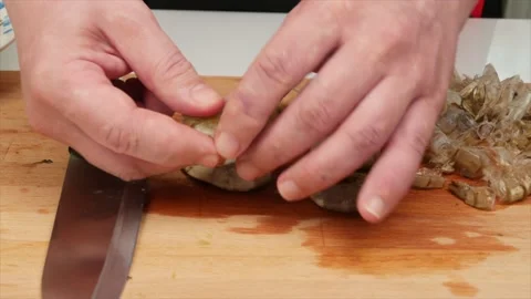 Man cuts shrimp for seafood Video stock 132285477
