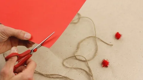Man cuts small red paper valentine heart, hand craft gift Video stock 122419602