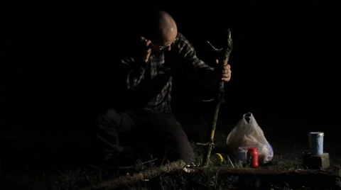 Man cuts a small tree at night Stock Footage 63953014