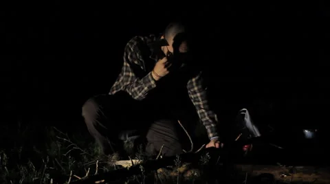 Man cuts a small tree at night Stock Footage 63953452