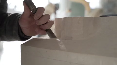 A man cuts stone with a chisel ( dust particules in slowmotion) Video stock 149127390