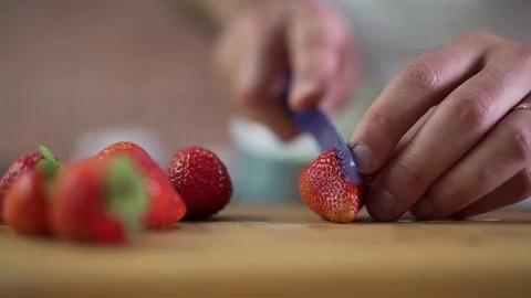 Man cuts strawberries clsoe up Stock Footage 79117971