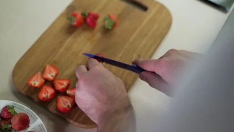 Man cuts strawberries clsoe up Stock Footage 79118232