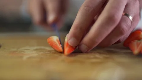 Man cuts strawberries clsoe up Stock Footage 79118587