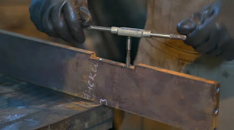 Man cuts thread in workshop Stock Footage 63537576