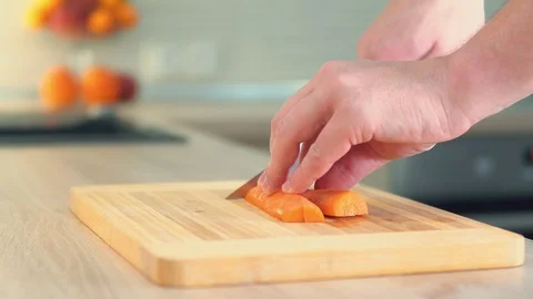 A man cuts vegetables on the board. Close-up Stock Footage 103173723