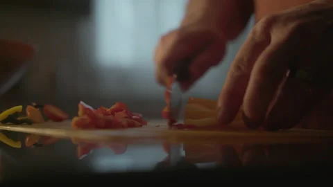 Man cuts vegetables for dinner Stock Footage 168113245