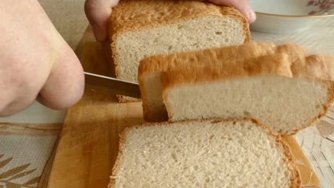 A man cuts wheat bread. the concept of healthy food Stock Footage 148022670